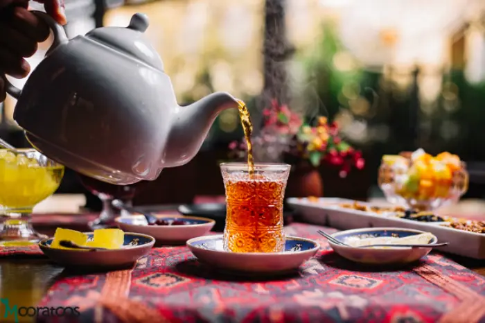 person-pouring-tea-armudy-jam-lemon-side-view_141793-3234